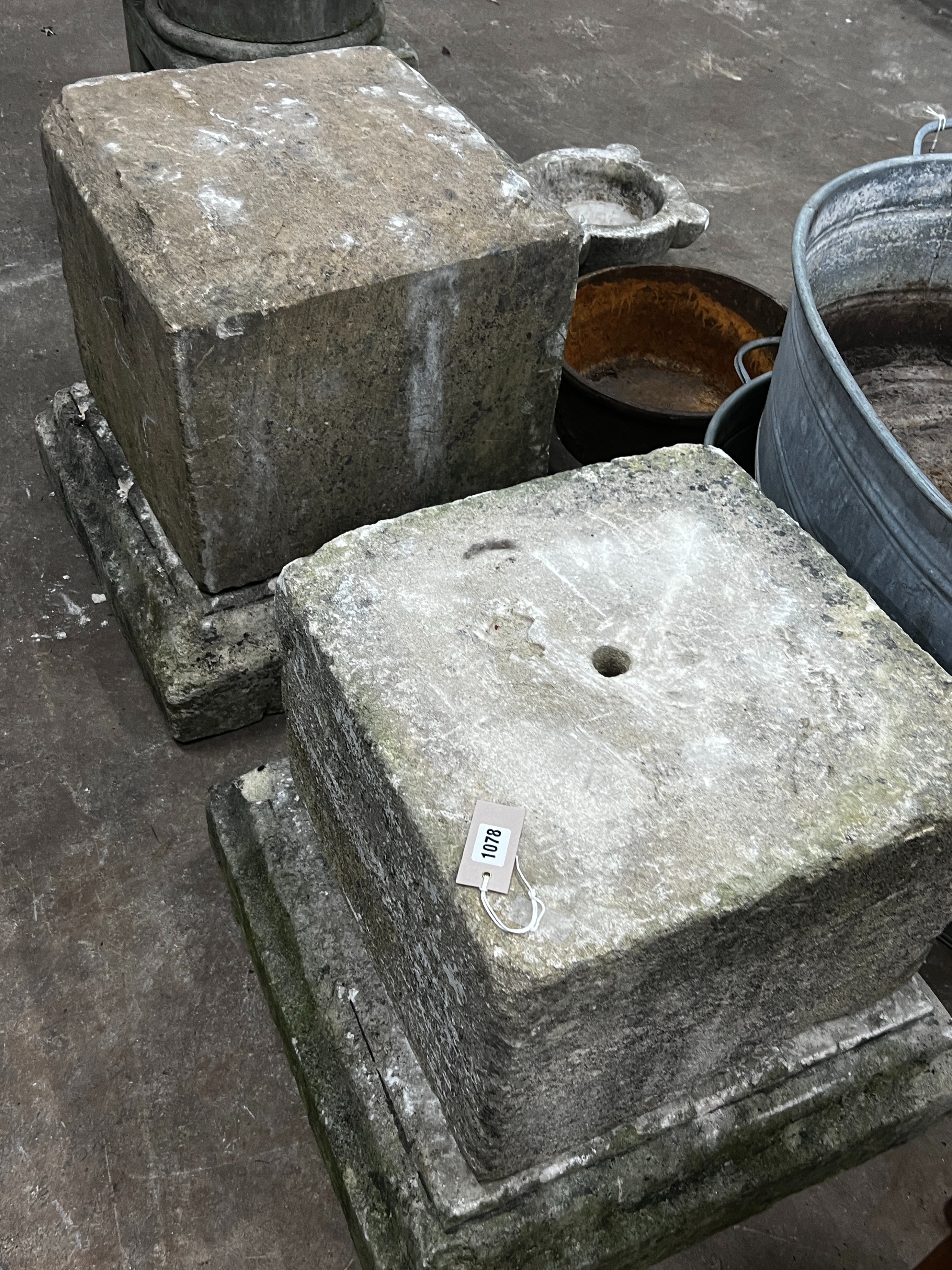 A near pair of carved stone plinths on bases, larger width 59cm, height 58cm
